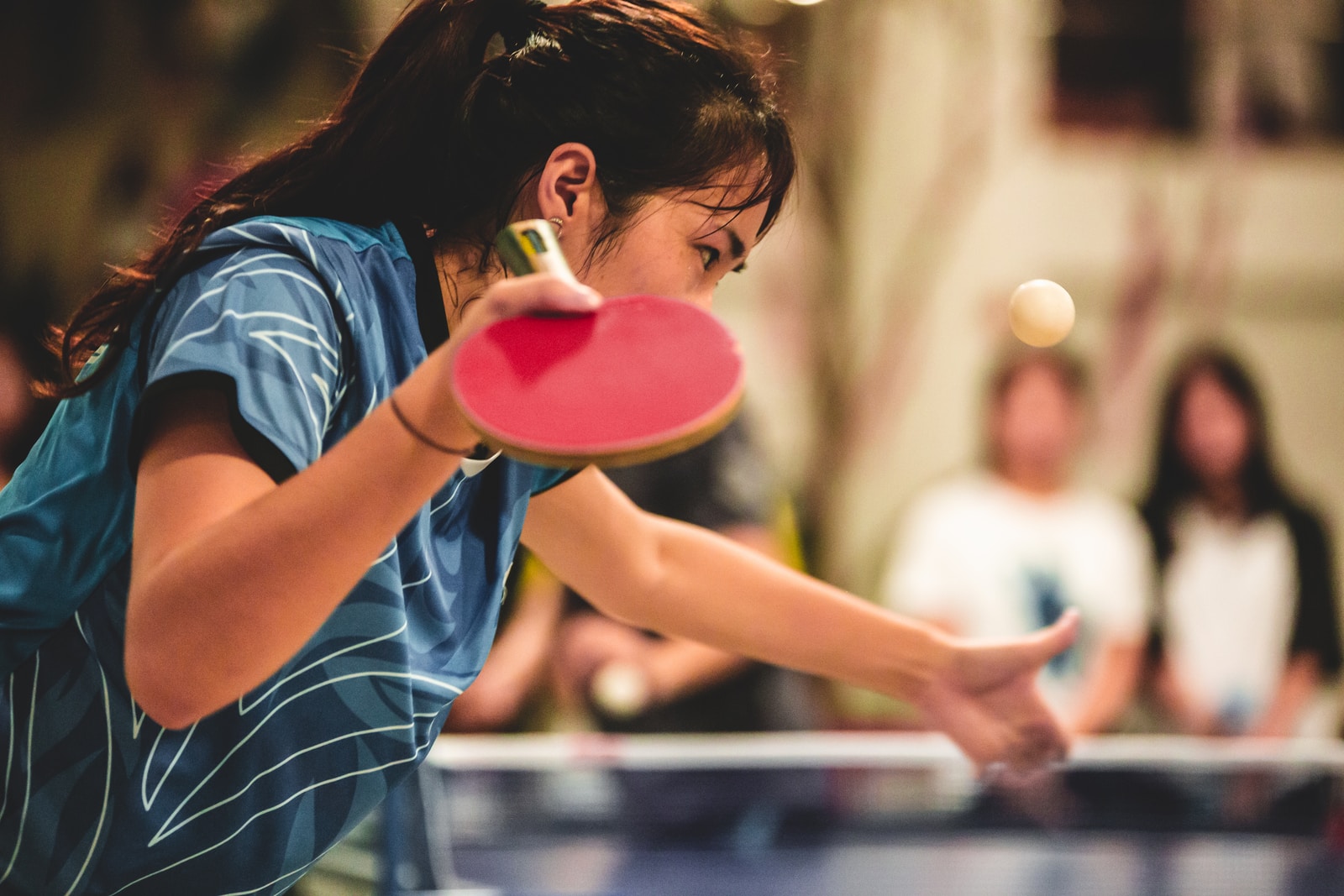 girl in blue and white striped shirt holding pink plastic cup